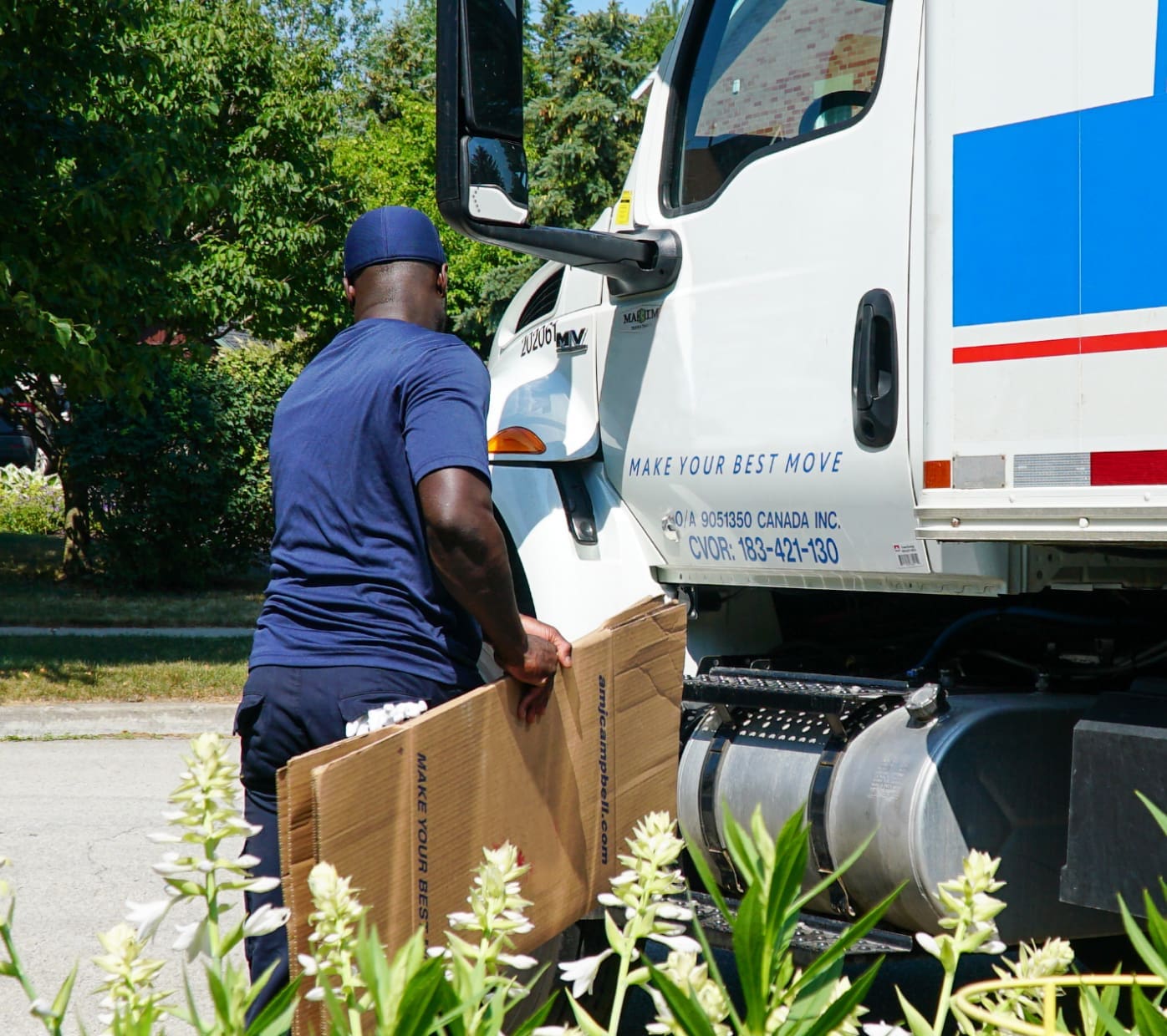AMJ Francise carrying empty moving boxes