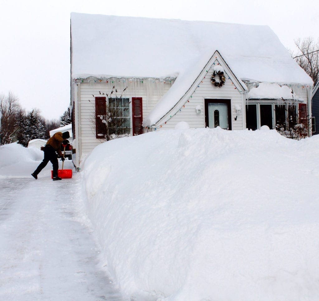 Man Shoveling snow at front of his house